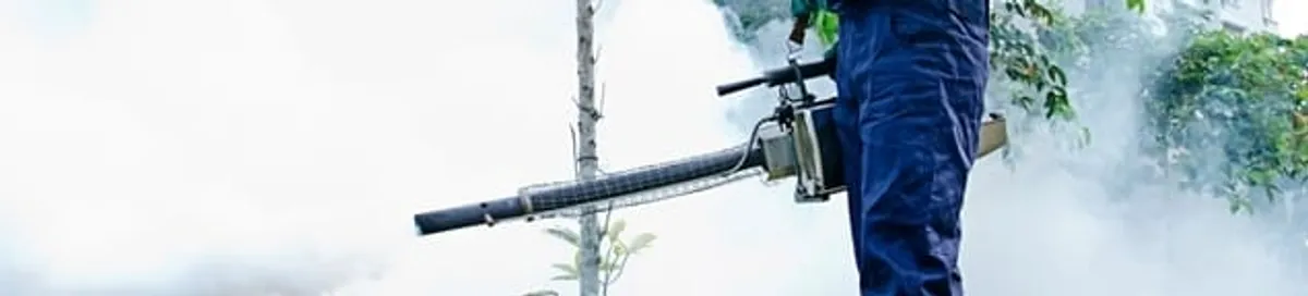 Pest control technician fogging an outdoor area for insect control in Cleveland, OH