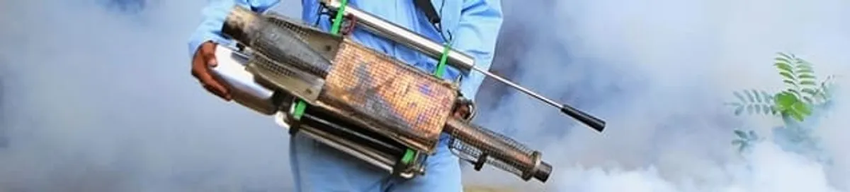 Fumigation technician using a fogger for deep pest treatment in Cleveland, OH