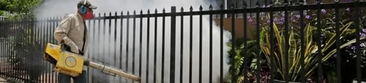 Mosquito control technician fogging a yard perimeter for mosquito reduction in Cleveland, OH